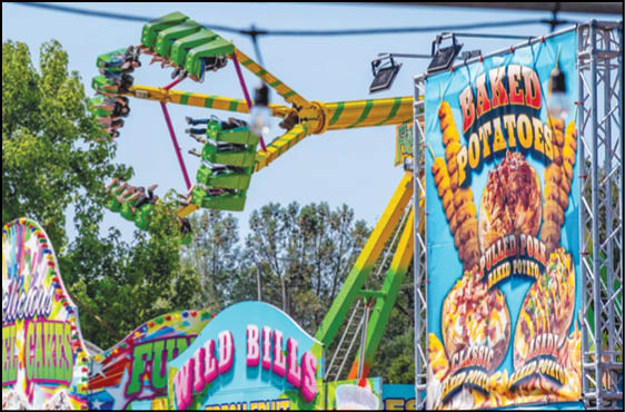 A blue and yellow tent with a sign that says “Buy or Reload Cards Here". Description generated by AI