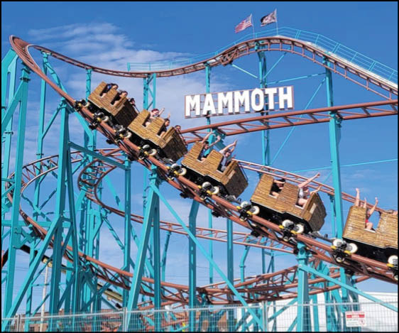 A green and blue roller coaster with a yellow center. Description generated by AI