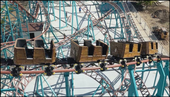 A green and blue roller coaster with a yellow center. Description generated by AI
