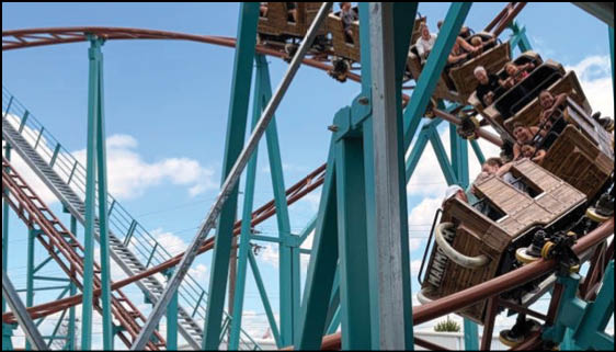 A green and blue roller coaster with a yellow center. Description generated by AI