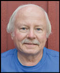 A man wearing a blue jacket and white shirt. Description generated by AI