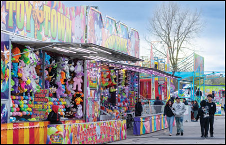 A blue and yellow tent with a sign that says “Buy or Reload Cards Here". Description generated by AI