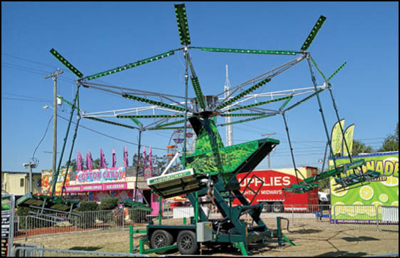 A group of people are sitting in a yellow ride at an amusement park. Description generated by AI