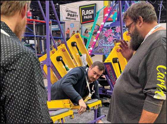 A group of people are sitting in a yellow ride at an amusement park. Description generated by AI