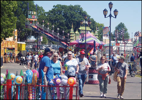 A carnival with lots of lights and rides. Description generated by AI