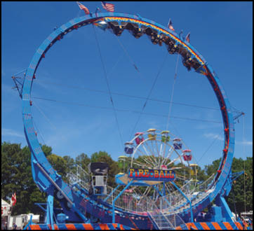 A carnival with lots of lights and rides. Description generated by AI
