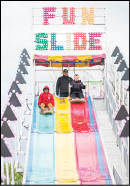 A blue and yellow tent with a sign that says “Buy or Reload Cards Here". Description generated by AI
