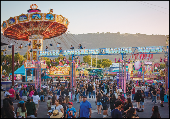 A carnival with lots of lights and rides. Description generated by AI