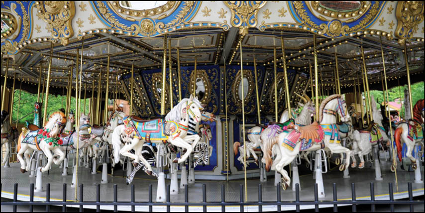 A group of people are sitting in a yellow ride at an amusement park. Description generated by AI