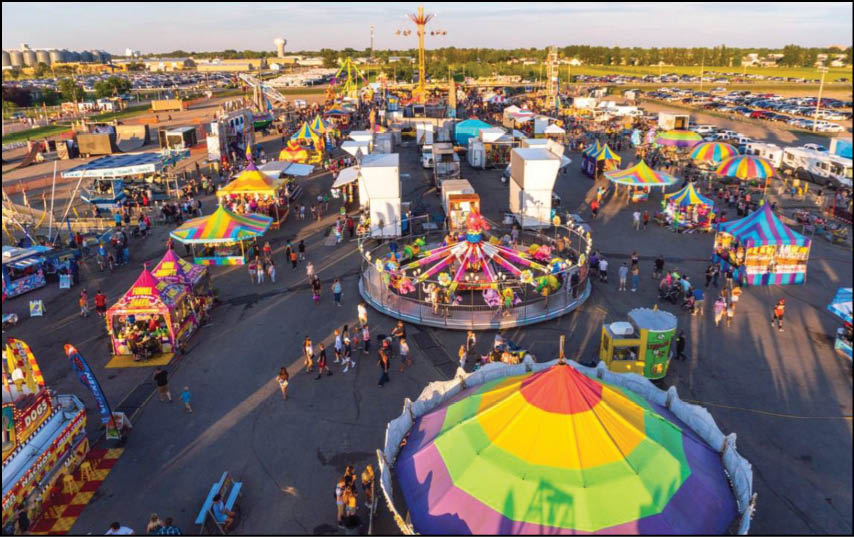 A carnival with lots of lights and rides. Description generated by AI