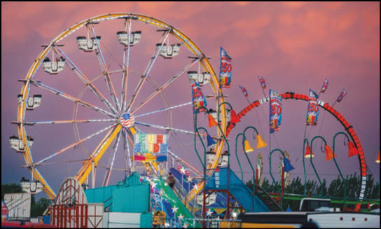 A carnival with lots of lights and rides. Description generated by AI