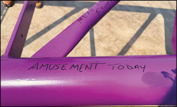A group of people are sitting in a yellow ride at an amusement park. Description generated by AI