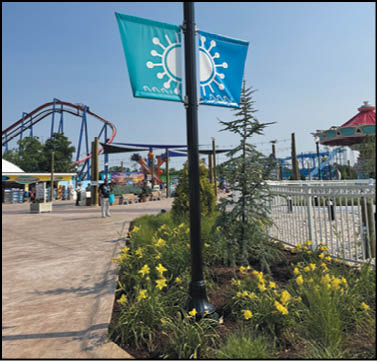 A group of people are sitting in a yellow ride at an amusement park. Description generated by AI