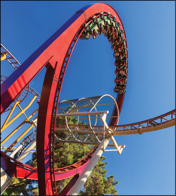 A group of people are sitting in a yellow ride at an amusement park. Description generated by AI