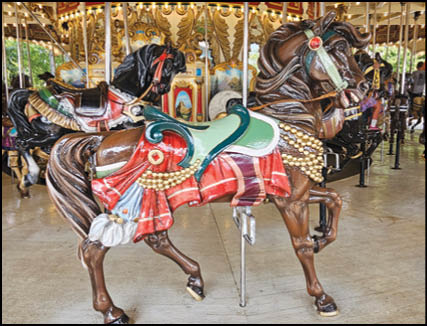 A group of people are sitting in a yellow ride at an amusement park. Description generated by AI
