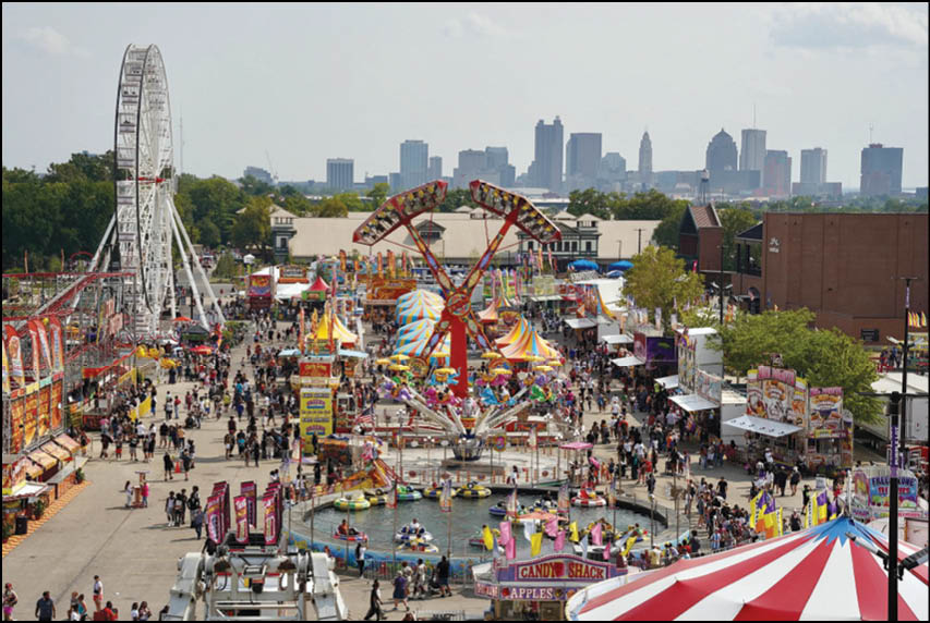 A carnival with lots of lights and rides. Description generated by AI
