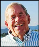 A man wearing a white shirt and black jacket. Description generated by AI
