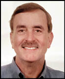A man wearing a white shirt and black jacket. Description generated by AI