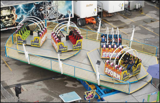 A carnival with lots of lights and rides. Description generated by AI