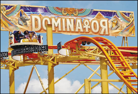 A carnival with lots of lights and rides. Description generated by AI