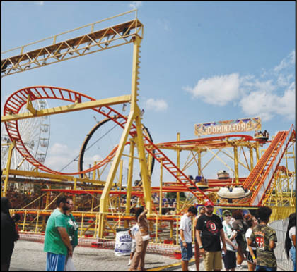 A carnival with lots of lights and rides. Description generated by AI