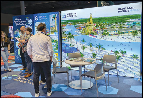 Adults stand and talk near a booth with a large colorful display showing a water park scene and the text Martin Aquatic and Blue Mar Basins. Description generated by AI